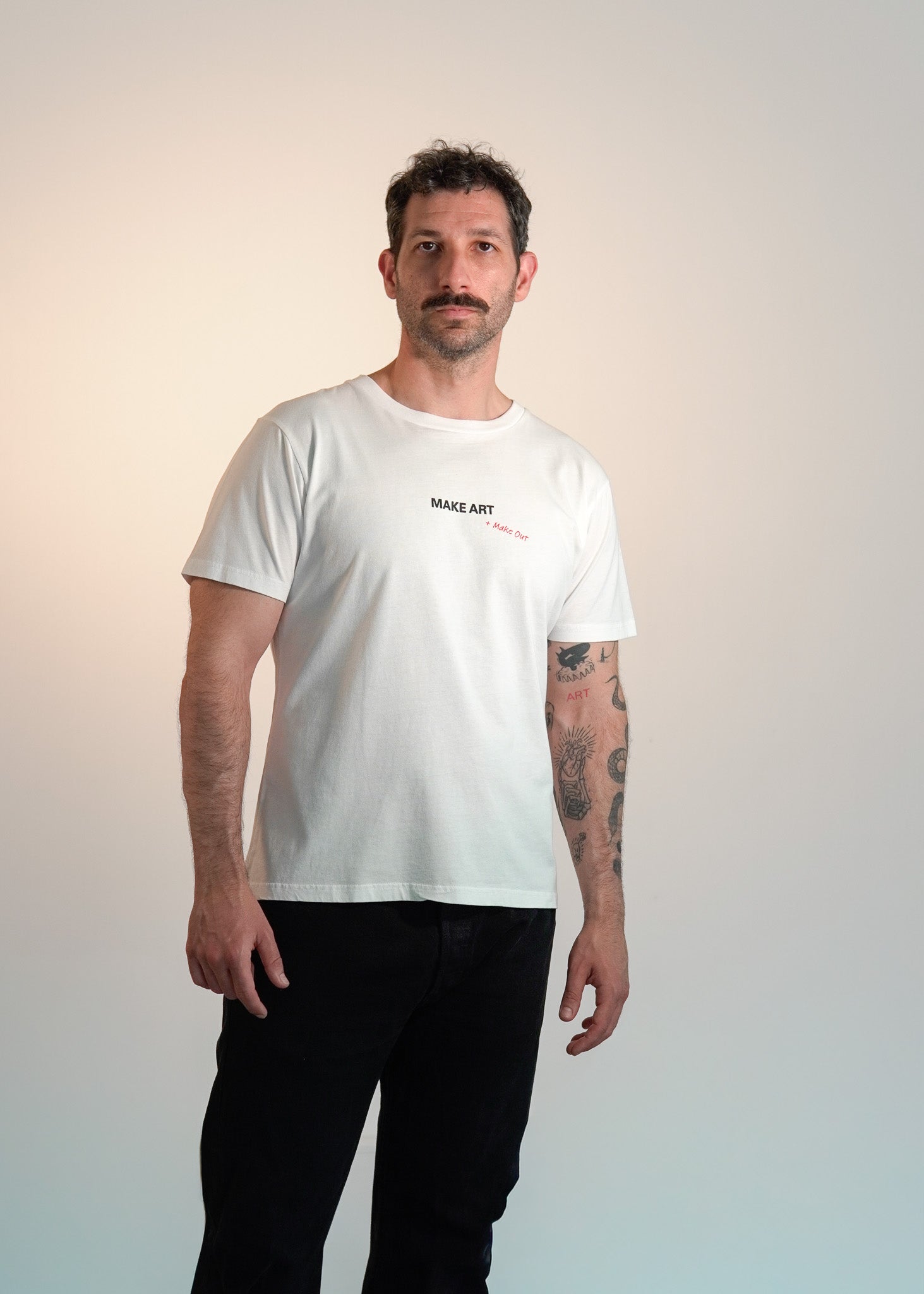 Man wearing a white t-shirt with text on a gradient background